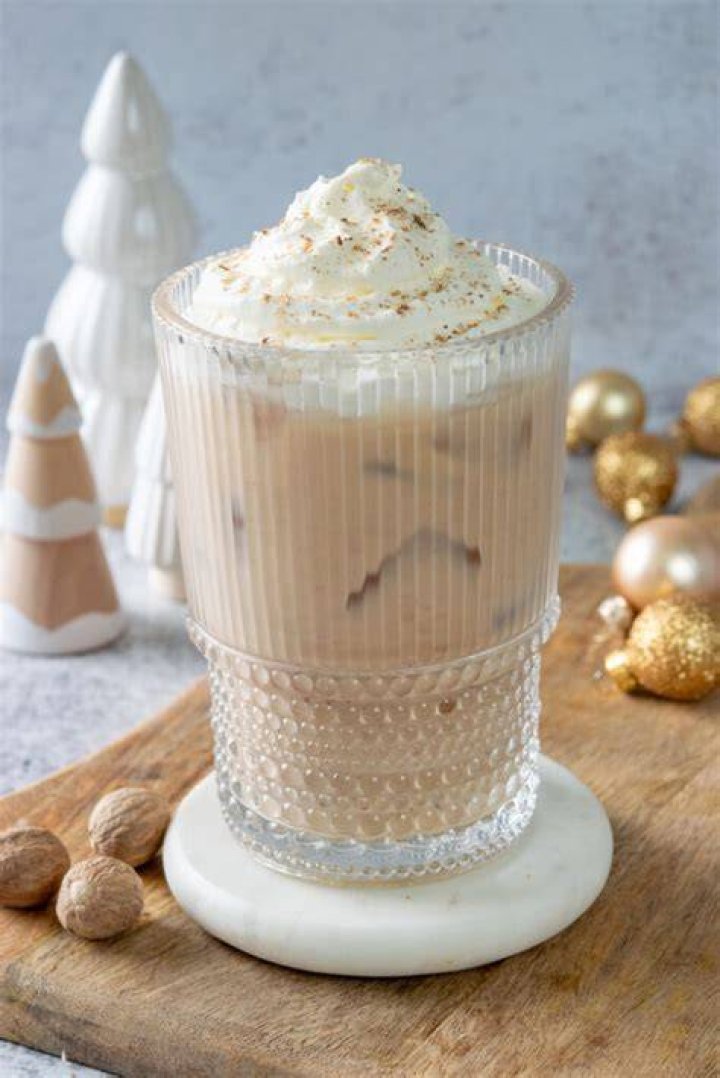Eggnog latte topped with whipped cream.