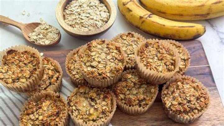 Ingredients for banana oatmeal muffins (bananas, peanut butter, oats, baking powder, maple syrup, eggs, milk).
