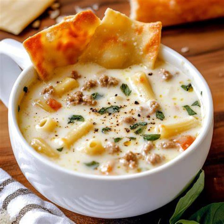 Lasagna Soup in a white bowl with melted cheese