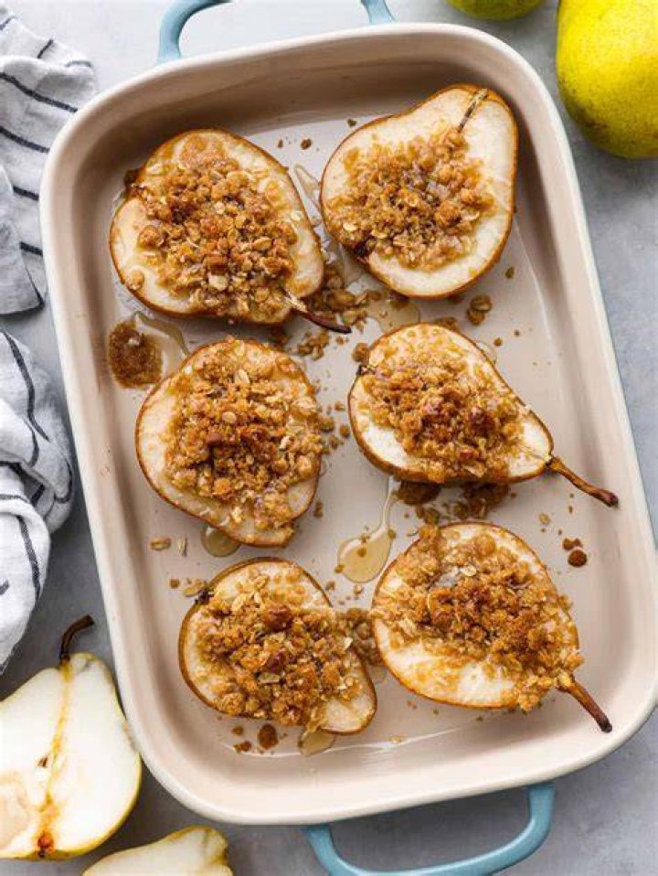 Pears in a baking dish topped with honey.